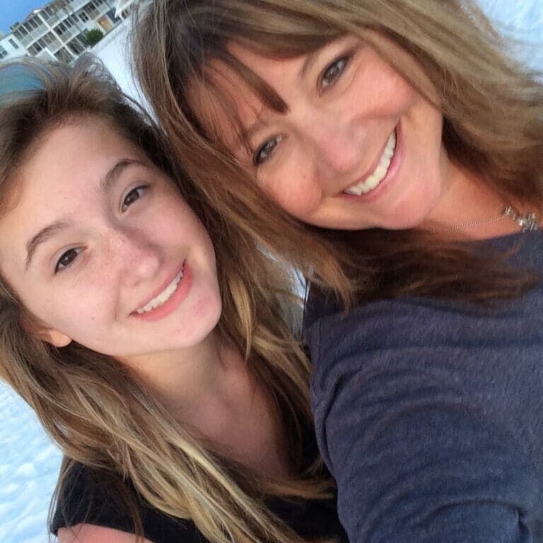 A woman and her daughter posing for the camera.